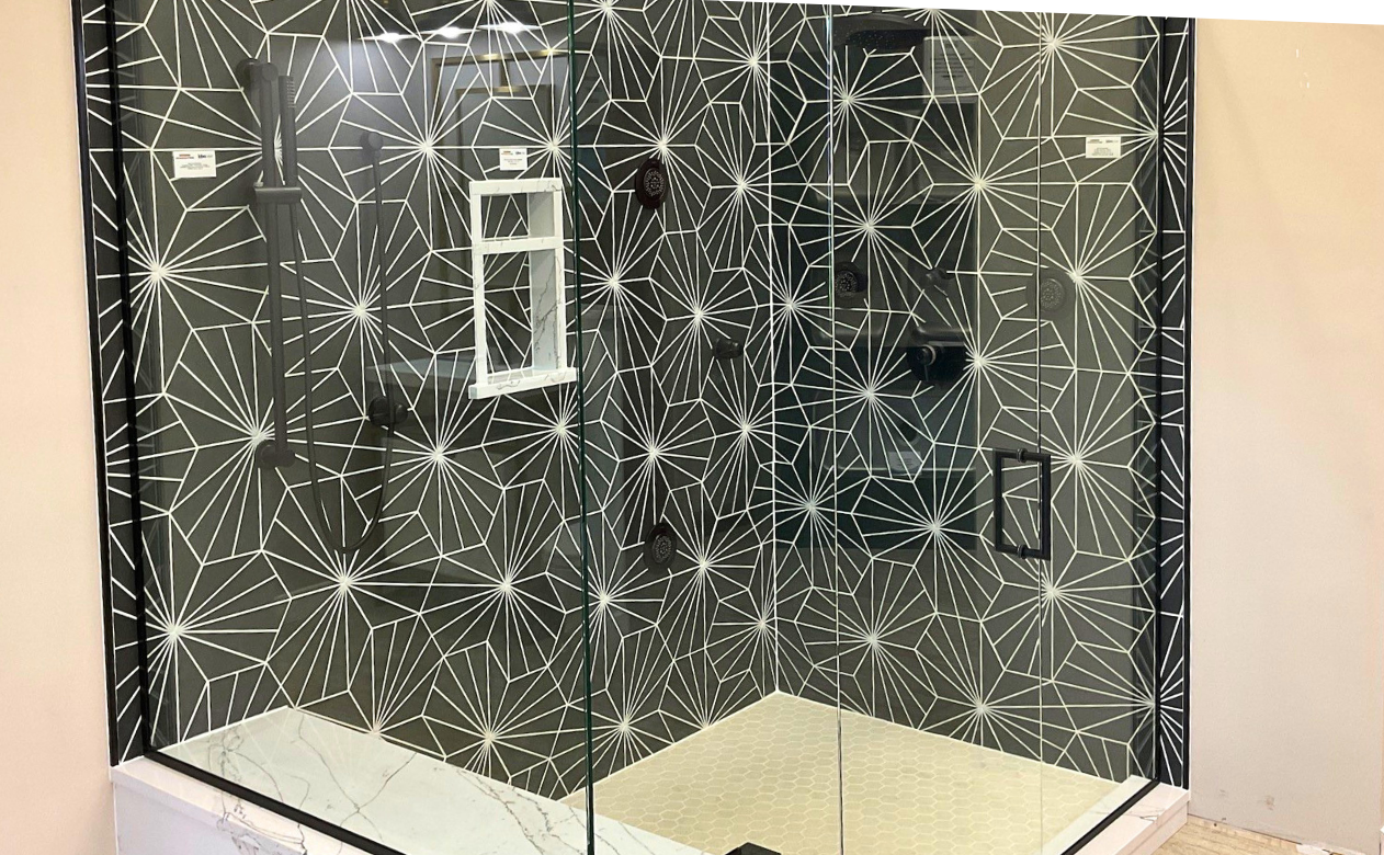 Black and white walk-in tiled shower at Kiba Studios in Rockford