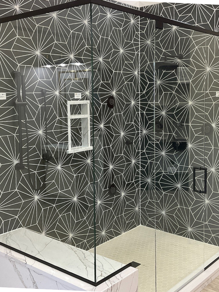 Black and white walk-in tiled shower at Kiba Studios in Rockford