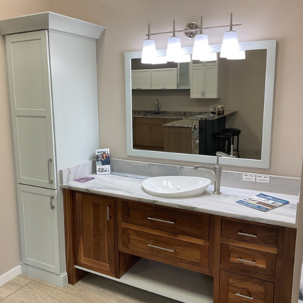 Cabinetry and a vanity in a bathroom with walk-in shower