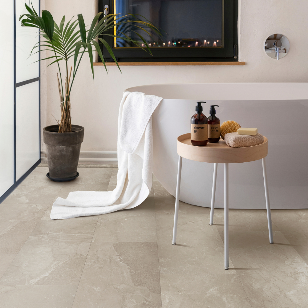 Tile flooring in a bathroom with freestanding bathtub and plant